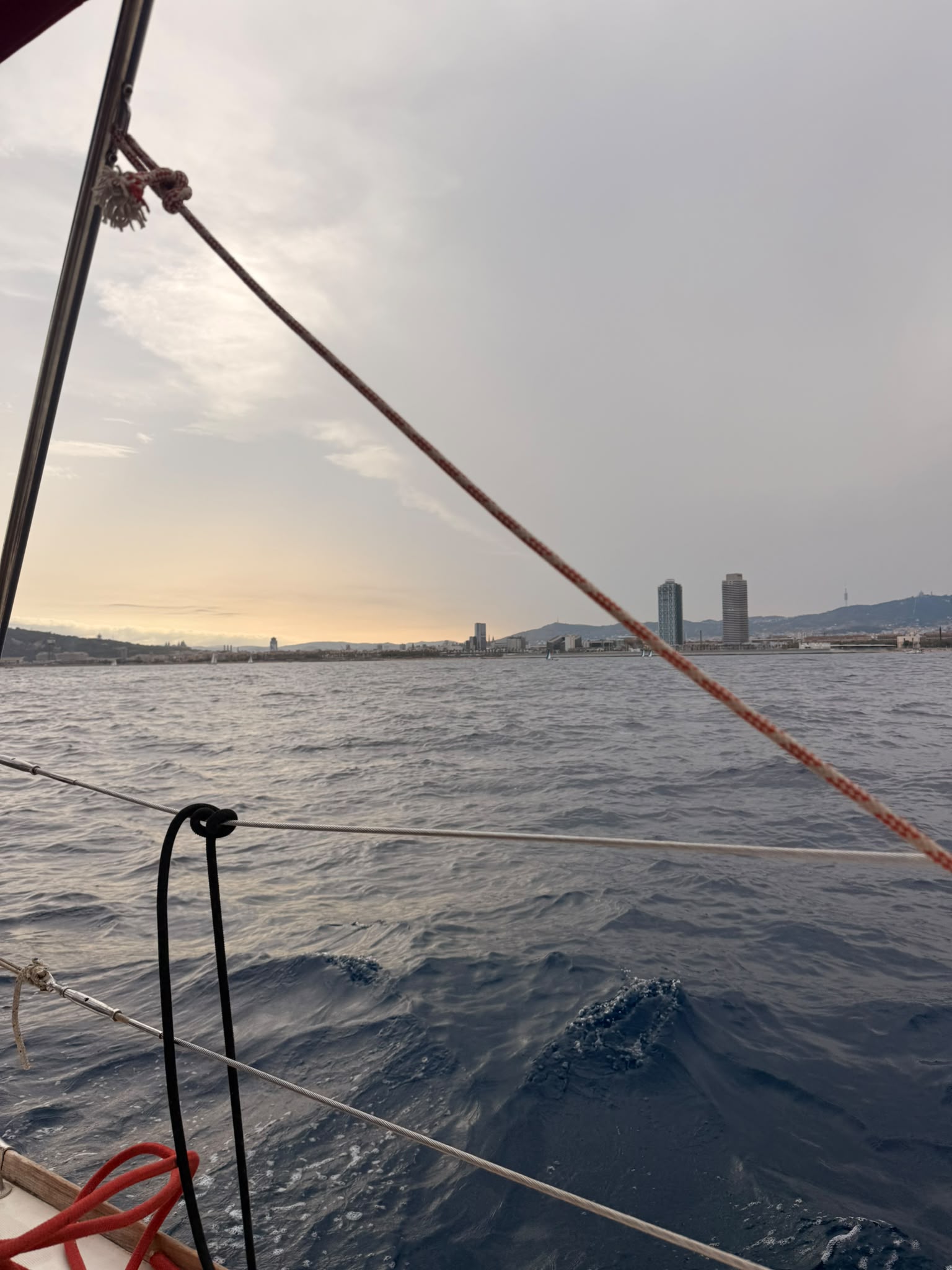 Sunset over the Barcelona coastline from the boat