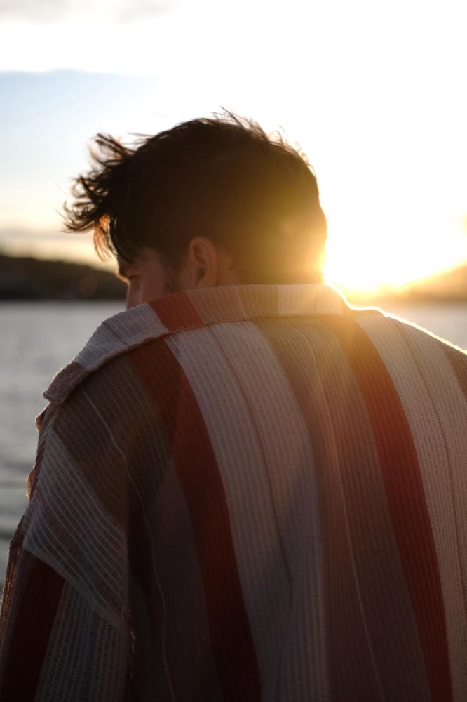 A guest backlit by the sunset on deck, Edition 02