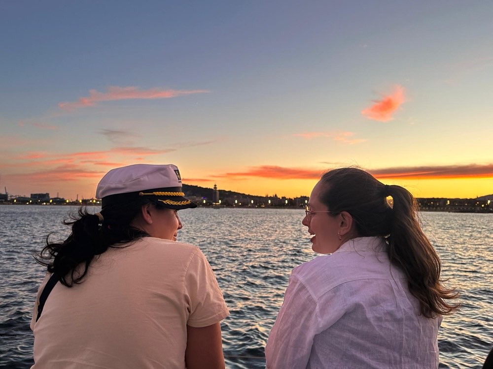 Two guests laughing together at sunset, Edition 02